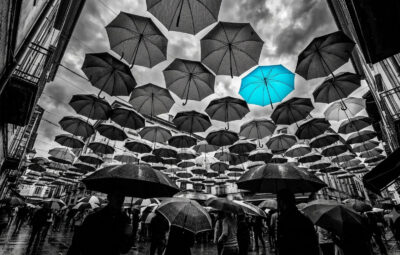 Umbrellas in the sky showing one standing out